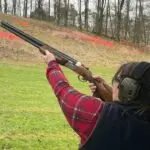 woman shooting a clay